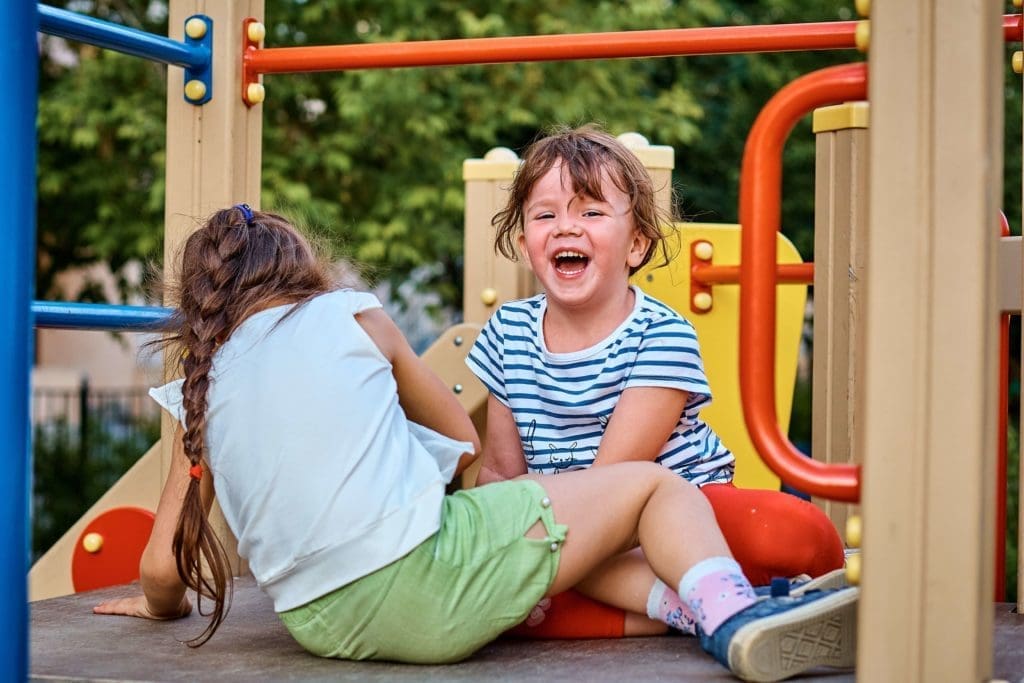 Attract Residents with the Best Amenities 1 amenities playground - image of children laughing in playground