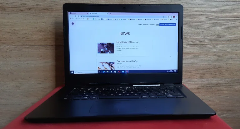 image of laptop with a HOA website open on news - it can be part of self-managed HOA software