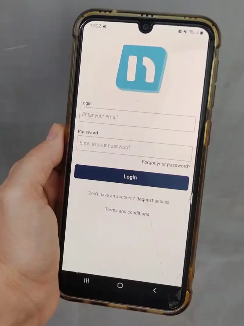 hand holding phone with neigbrs by vinteum app against a grey background