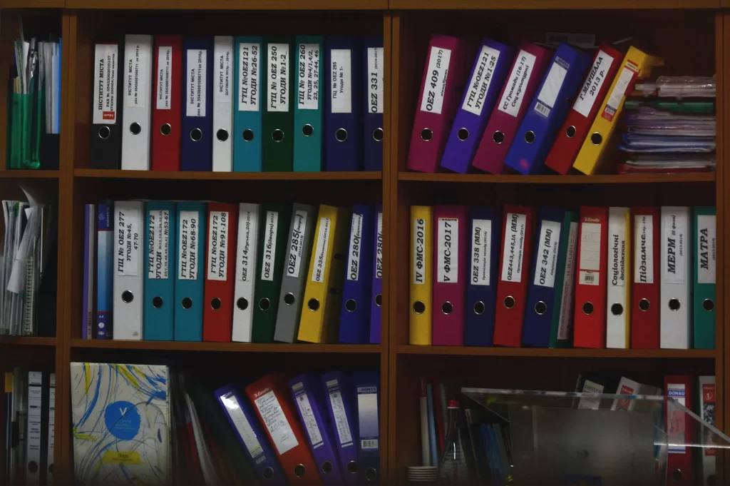 HOA Records: Understanding the Rules 1 3 shelves full of colorful folders representing HOA records