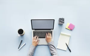 Image depicting a computer, notepad, and post-it notes, symbolizing the creative process of designing home inspection company logos