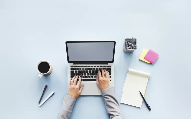 Image depicting a computer, notepad, and post-it notes, symbolizing the creative process of designing home inspection company logos