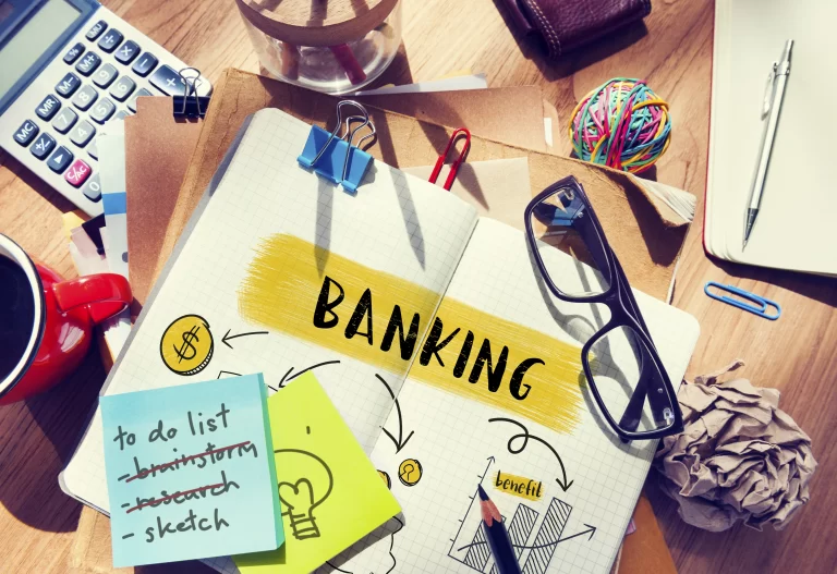 Image of a desk with HOA budget preparation materials including post-it notes, calculator, and paper, illustrating organized financial planning