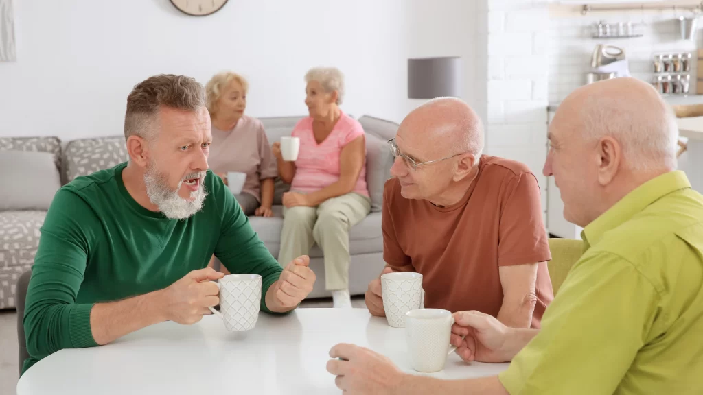 Benefits of being on an HOA board: 5 HOA board members having an informal meeting. They are having coffee and talking