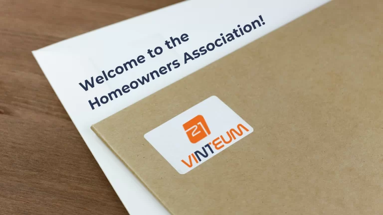 An HOA welcome letter, written: welcome to the homeowners association and an envelope from Vinteum