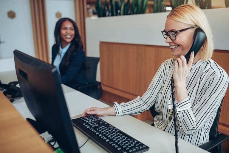Smiling businesswoman working with a colleague at an office reception